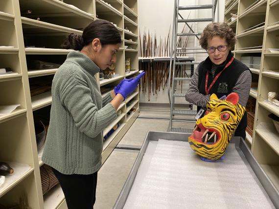 Emily Castorena with Rebecca Andrews researching a Jaguar Mask at the Burke Museum’s Cultural collections.