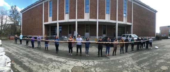 Students hold the bear intestine after scraping in front of the Burke museum. Photo courtesy of Sven Haakanson