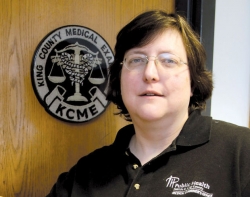 Kathy Taylor in front of the KCME seal