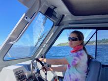 Maddy Henley driving a boat
