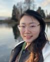 Tess Chen standing in front of Green Lake in Seattle