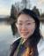 Tess Chen standing in front of Green Lake in Seattle