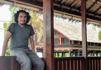 Dimas Romadhon sitting on a railing in Aceh Indonesia