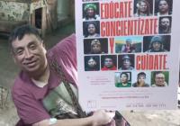 Willy Morales, indigenous male and leader of RENPO, holding one of the latest campaign posters. He is in a wheelchair.