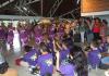 UW students (in purple T-shirts) being welcomed by dancers at the airport in Huahine