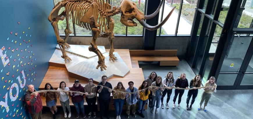 Ethnoarchaeology students holding up the inflated processed bear intestine. 2020.