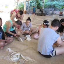 UW students learning how to pound bark cloth, Tahiti